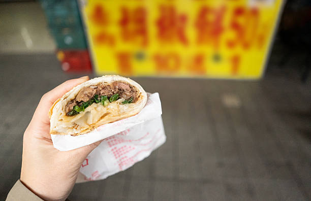 Eating pepper buns on the streets of Taiwan.Street Snack.