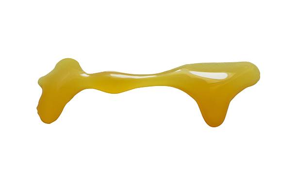 istock yellow honey splashes isolated 2241314641