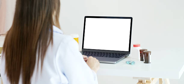 istock Laptop mock up, Laptop computer with blank screen and medicines on docter table 2241315455