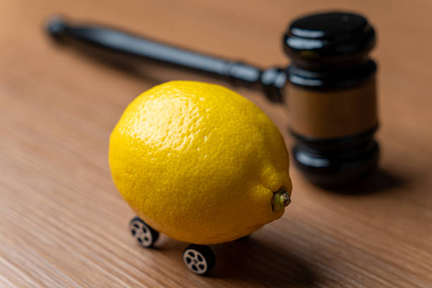 istock A lemon with small wheels placed near a judge's gavel. 2241316494