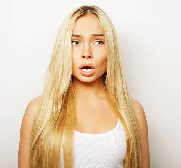 Beautiful young surprised woman. Long blond hair and cute face.