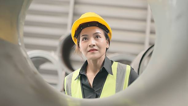 istock Production staff in the assembly line examine mechanical components and record data for quality assurance. Engineers provide guidance and technical support to improve productivity and reduce downtime. 2241319152