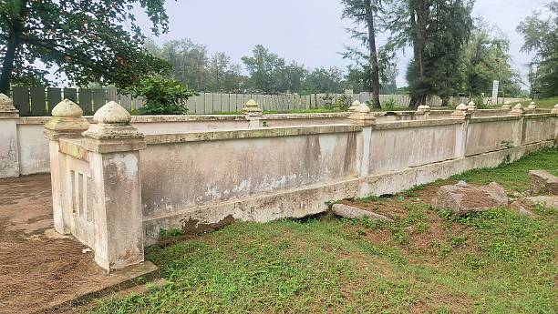 A dilapidated abandoned bridge in the park. A dilapidated and abandoned concrete cement wall of a path