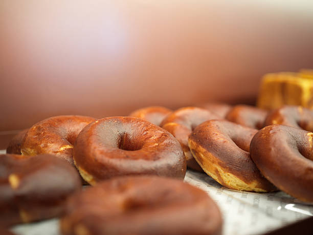 istock Freshly Baked Donuts Displayed on a Tray with a Warm Background 2241322838