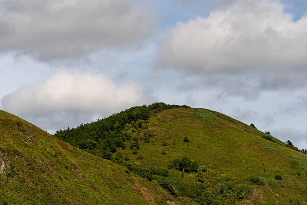 istock Verdant mountain ridge rising beneath cloudy atmosphere 2241323547