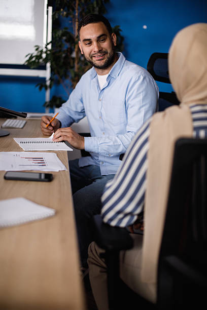 istock Business meeting in a modern office with charts, notes, and a friendly discussion between colleagues 2241324380