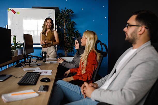 istock Team at a modern office presenting to colleagues during a lively brainstorming session 2241324922
