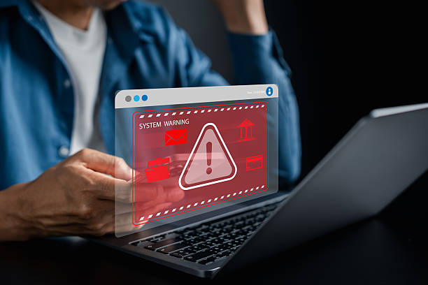 istock Financial security and system warning with laptop and smartphone, red alert screen risk, fraud, and data protection issues, cybersecurity in online banking. 2241330931