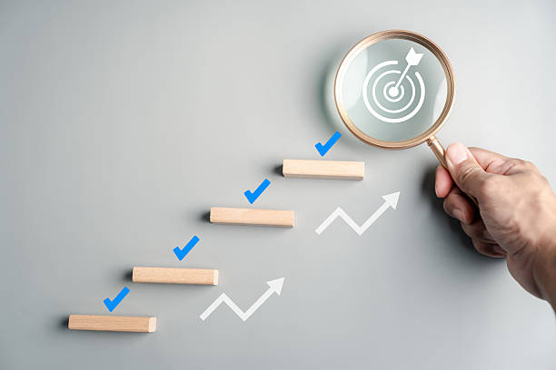 istock Planning and achievement with wooden blocks arranged as steps, check marks, magnifying glass with target icon, progress, goal setting, and business success. 2241330949