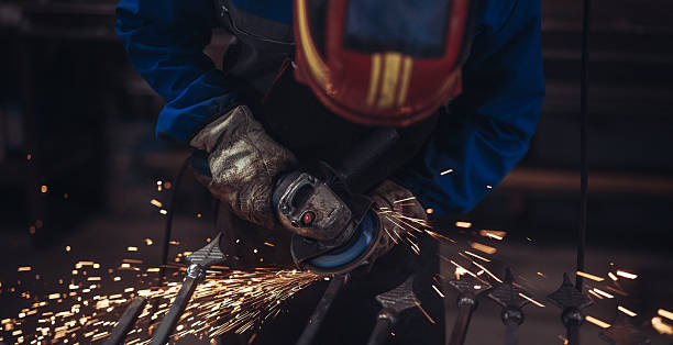 istock Metalworker Grinding Iron Fence with Sparks 2241331932