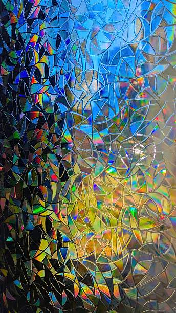 istock Abstract colorful background with iridescent geometric pattern resembling stained glass. Multicolored texture with blue, yellow, and rainbow reflections creating a vibrant light play and modern artistic effect. 2241332016
