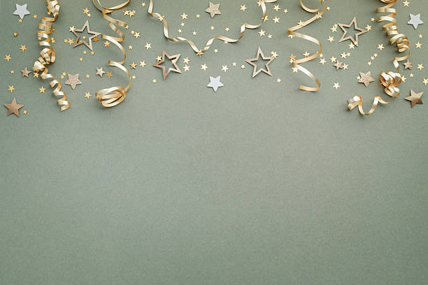 istock New Year, Christmas or birthday festive background top view. Celebration composition with golden confetti stars and serpentine party streamers. 2241332163