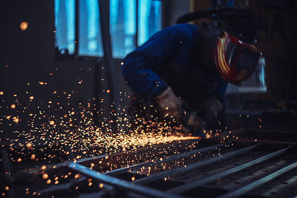 istock Metalworker Grinding Iron Fence with Sparks 2241332907