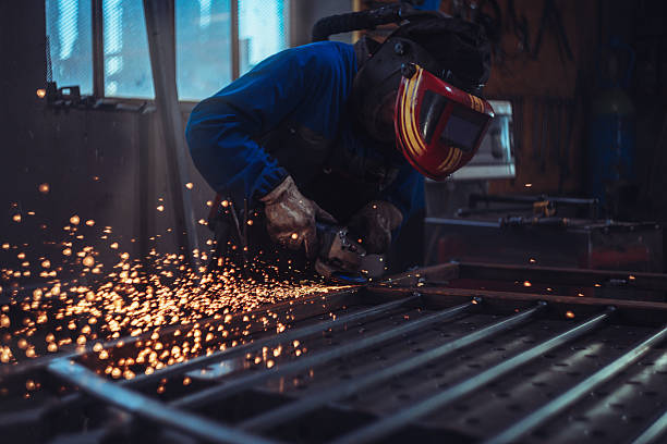 istock Metalworker Grinding Iron Fence with Sparks 2241332908