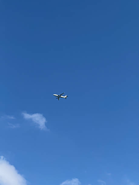 istock Small Airplane Flying High in the Clear Blue Sky 2241335122