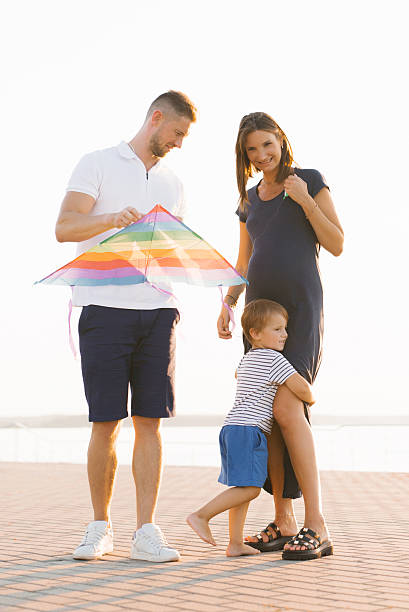 istock Parents And Child Preparing A Bright Kite 2241339058