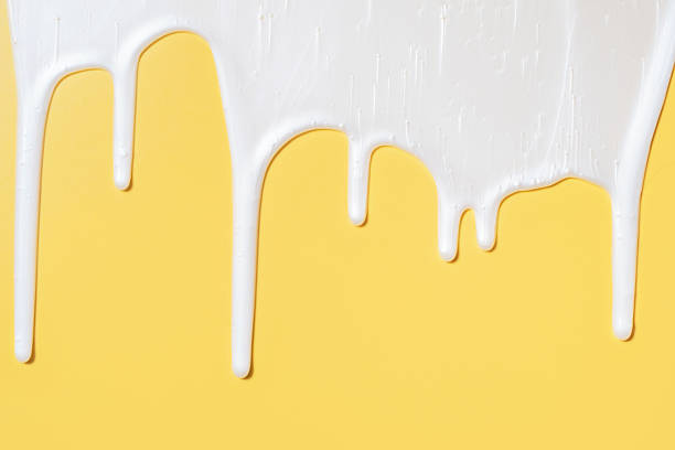 istock liquid moisturizing shampoo dripping down on yellow background close-up. 2241339237