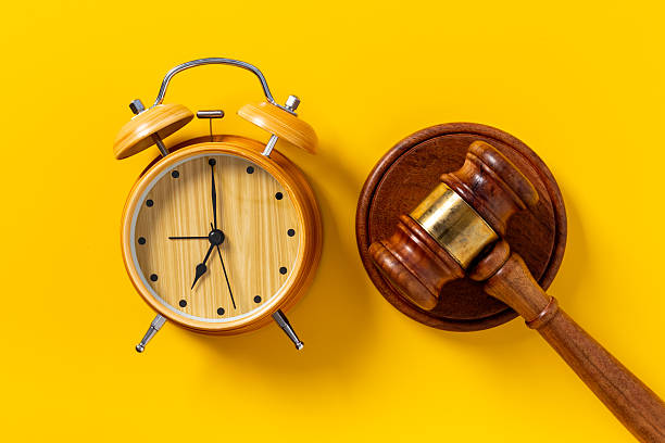 istock Alarm clock judges gavel, top view. Deadline and time management concept 2241342731