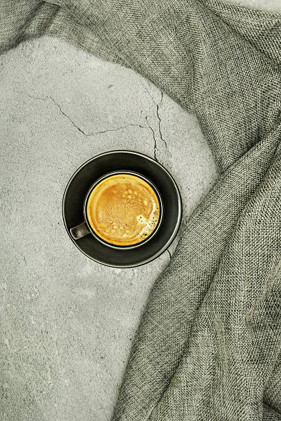 istock Central image of a freshly poured cup of coffee on a gray surface. 2241347555
