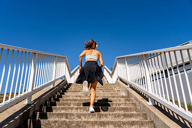 Active woman running up stairs outdoors for a workout.