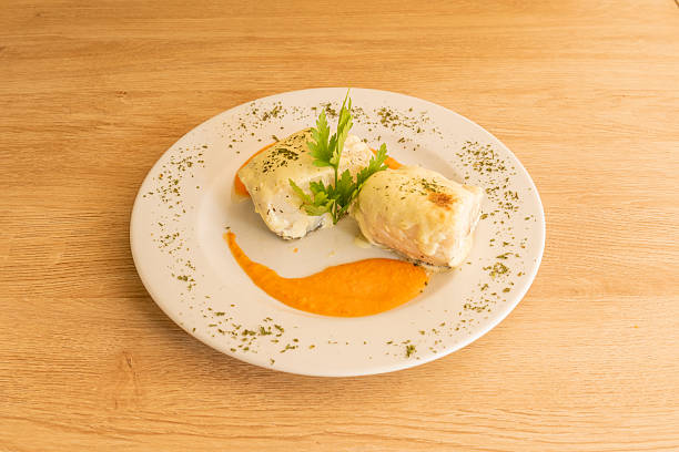 istock Spanish recipe for confit cod with pumpkin cream and lots of chopped parsley 2241349810