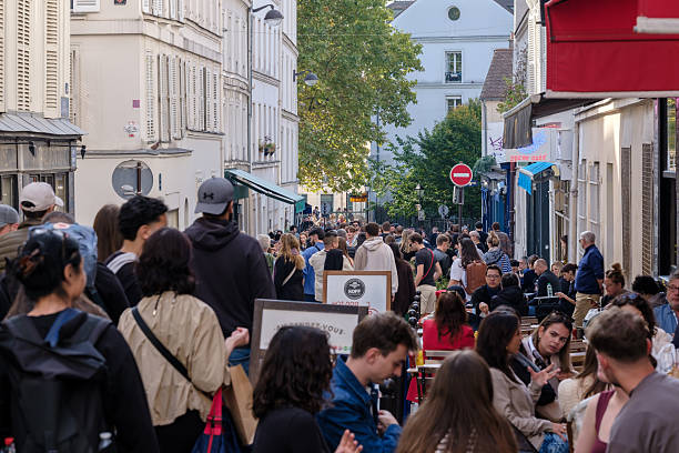 Paris, France - October 11, 2025 : View of the very busy pedestrian street full of cafés and restaurants in Montmartre Paris France