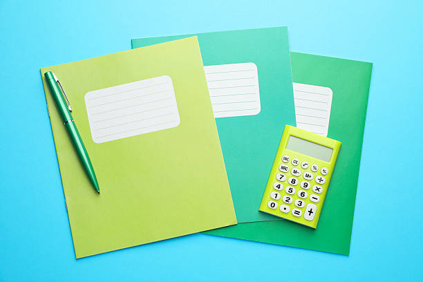 istock Copybooks, calculator and pen on light blue background, top view 2241350690