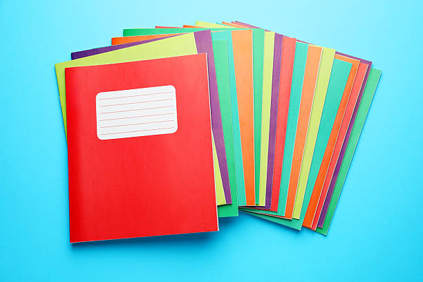 istock Colorful copybooks on light blue background, top view. School stationery 2241350711