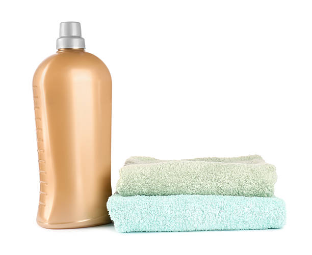 istock Bottle with laundry detergent and clean towels isolated on white 2241350908