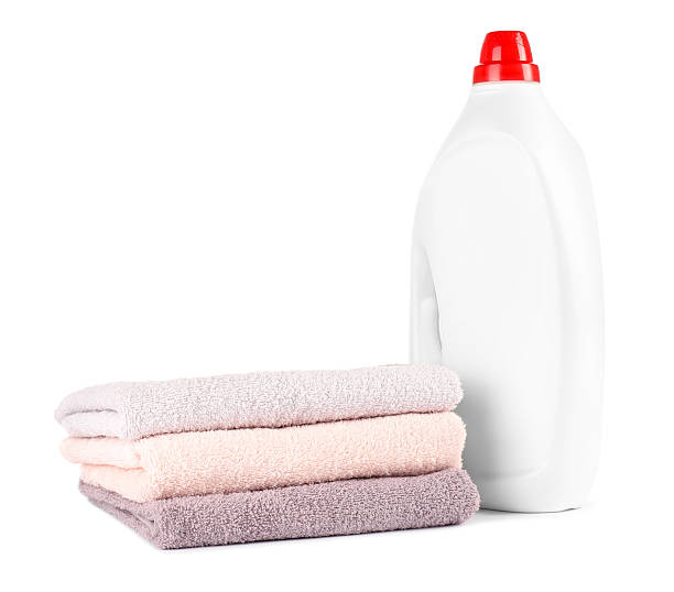istock Bottle with laundry detergent and stack of clean towels isolated on white 2241350926