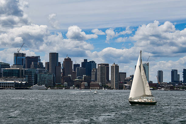 Large Schooner along the Boston Harbor Skyline. The Boston cityscape is a mixture of old and new buildings. Boston is the capital and largest city in Masssachusetts. Boston is the largest city in New England 