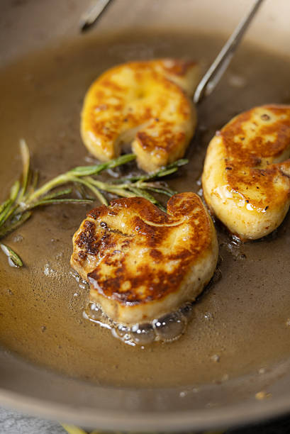 istock Sizzling pan-seared foie gras with fresh thyme sprigs in a hot skillet, creating a rich, aromatic French gourmet delicacy 2241353108