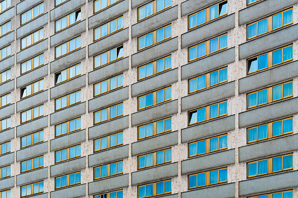 istock Geometric high-rise facade with repetitive window patterns and subtle color contrast in modernist style 2241355984