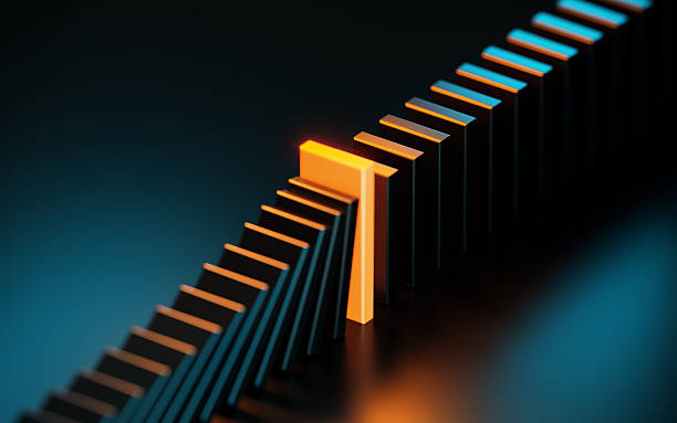 istock Black And Orange Colored Dominos On Dark Background - Leadership Concept 2241356146