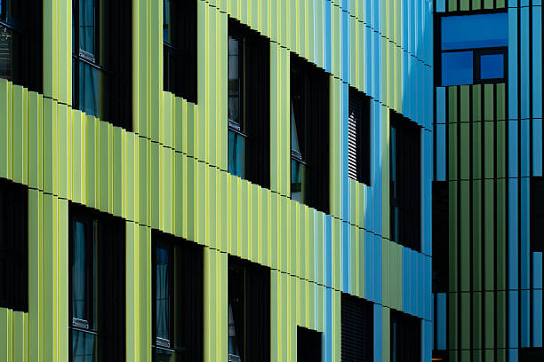 istock Modern architectural facade with vertical green and blue panels creating a rhythmic geometric design pattern 2241356853