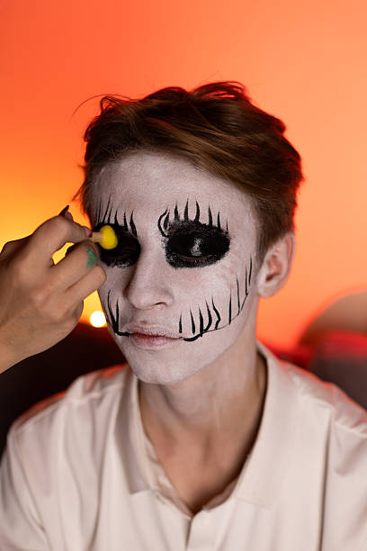 istock A model is getting their face painted for a Halloween costume 2241357029
