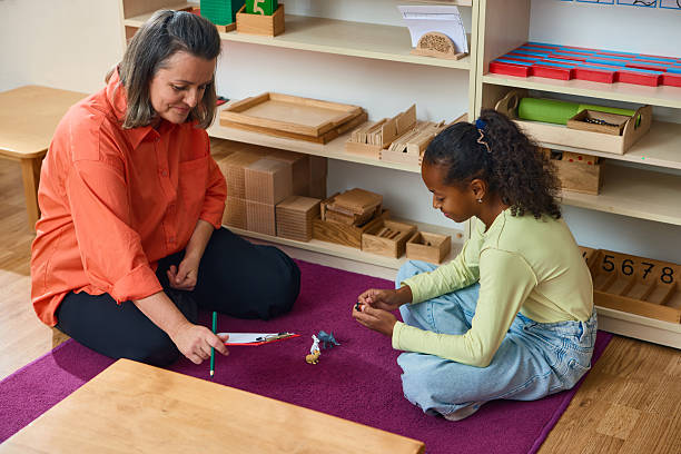 istock Teacher and child playing with toys during therapy session for learning and emotional support 2241360079