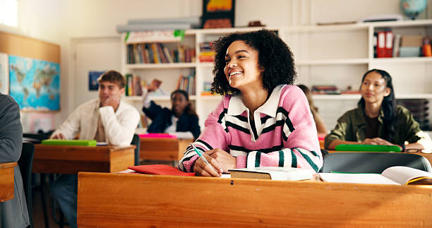 Learning, class and happy girl listening in high school for notes, education and academic knowledge. Teen students, smile and study in academy for geography lesson, scholarship course or development