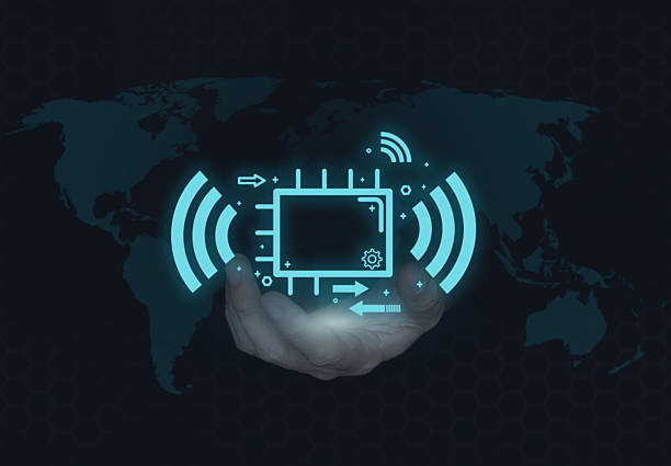 Hand holding digital IoT chip with wireless signal icon over global world map background. Concept of smart technology, data communication, AI innovation, network connectivity, and futuristic digital system.