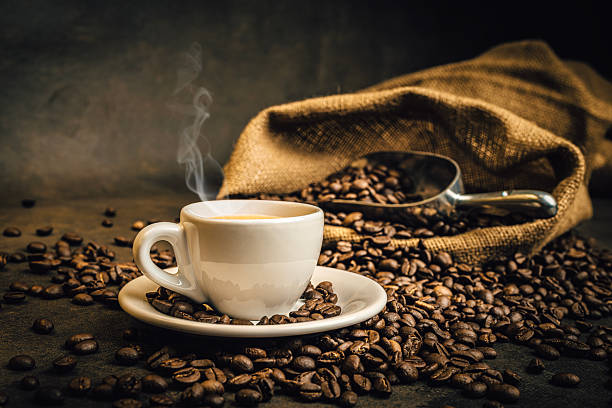 istock Steaming espresso cup with roasted coffee beans and burlap sack 2241364502