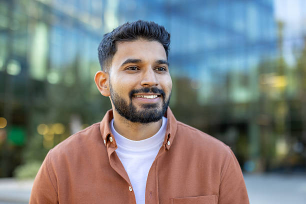 istock Young indian businessman smiling outside office building 2241365404