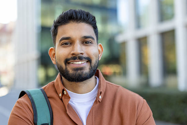 istock A cheerful Indian man with a beard smiles outdoors, possibly a student or professional. 2241365418