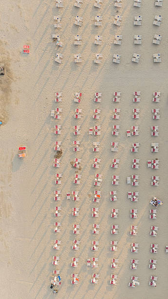 istock Organized Pattern of Sunbeds and Umbrellas on Sandy Beach From Above 2241366240