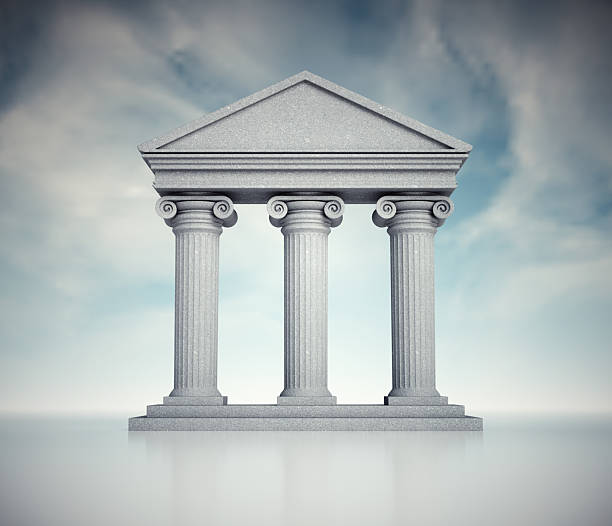 istock Classic stone temple with three columns set against a cloudy sky background 2241367888