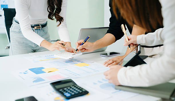 istock Team work process. Photo young business crew working with new startup project. Project managers meeting. Analyze plans, papers. At office 2241371547