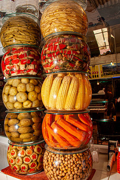 Pickled tomatoes, cucumbers, corn, carrots etc. in glass jars