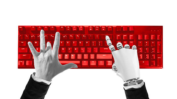 Composition of human and robotic hands typing on red keyboard symbolizing digital cooperation