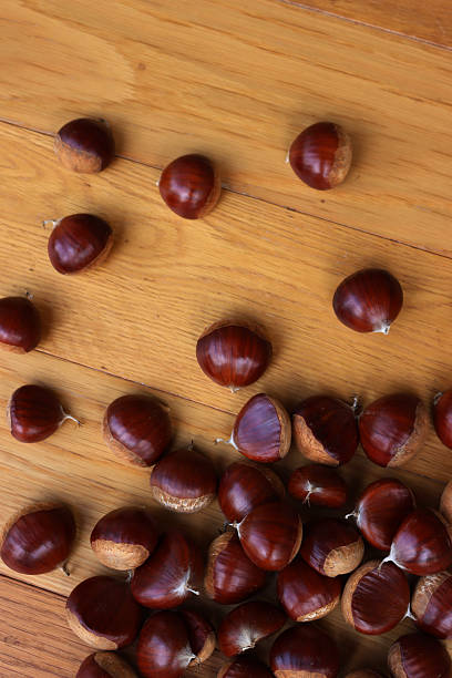 istock Chestnuts on wooden table on selective focus with copy space 2241375639