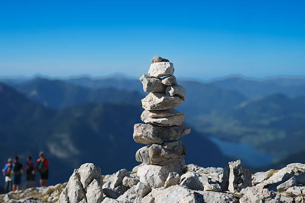 istock Stone pyramid in the mountains on the summit and ountain pass marking the trail 2241378276