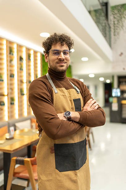 istock Confident man small business owner smiling in cafe 2241378455